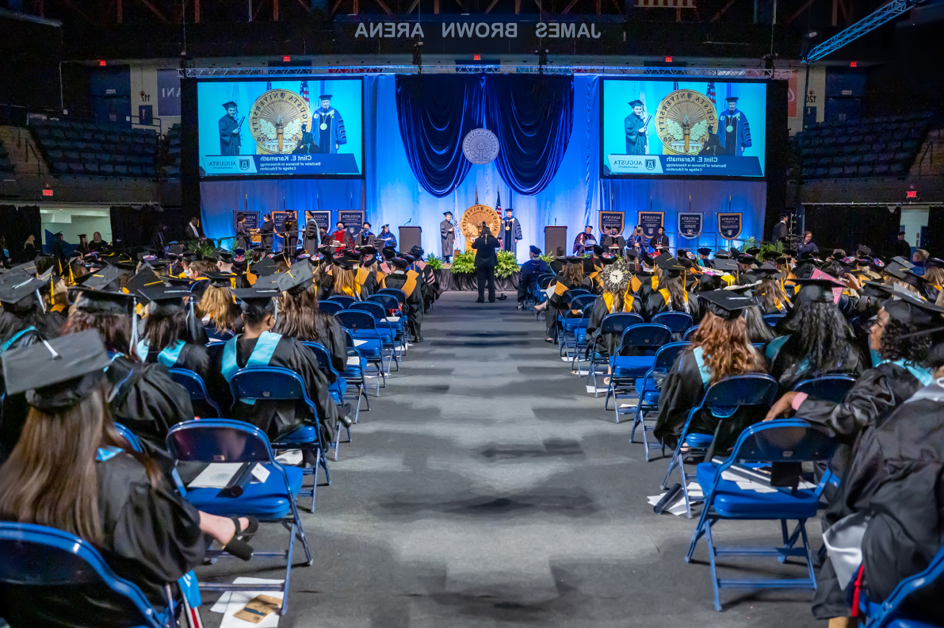 Augusta University graduation showing a student accepting his diploma from the President of the college.